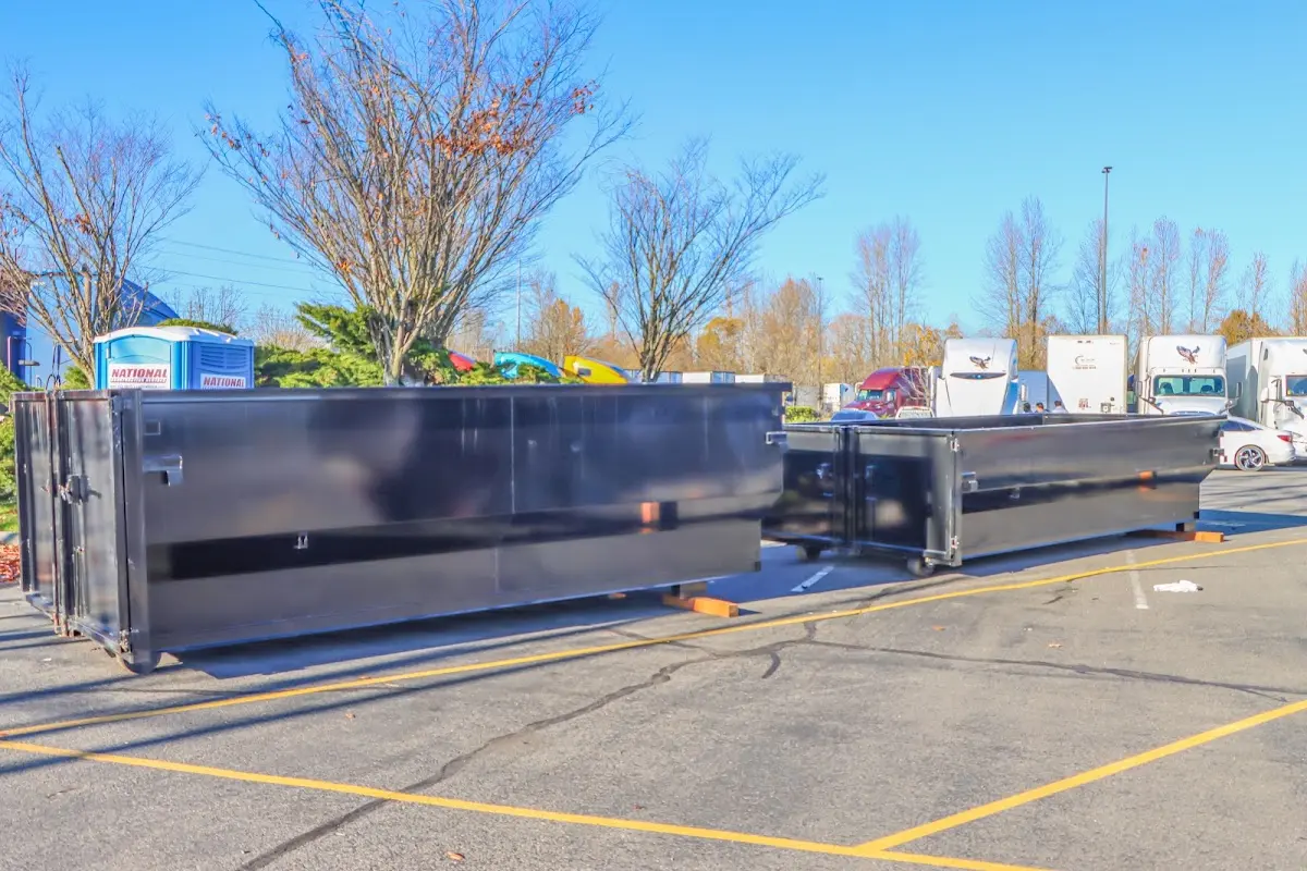 Professional dumpster rental service with roll-off container on residential driveway in Ridley